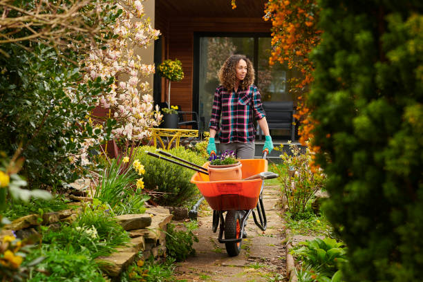 Woman taking her tools down the garden